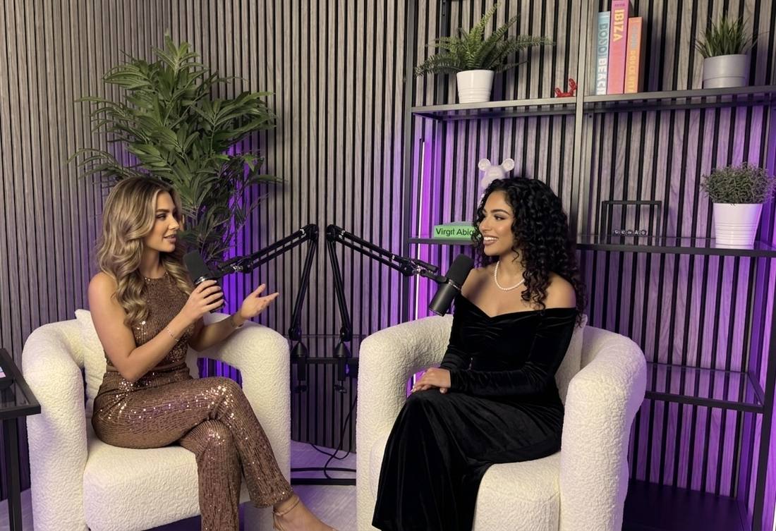 Two women in eveningwear recording a special edition podcast